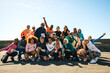 © Jacob Lund - Cheerful running club group photo under the bright blue sky