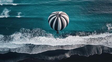 Canvas Print - Hot air balloon over ocean waves, black sand beach, aerial view, travel