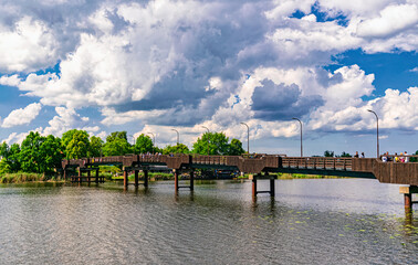 Wall Mural - Old wooden footbridge over the river