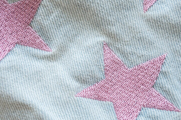 pink star patch on jeans texture background