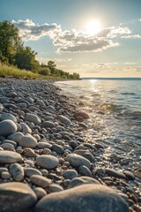 Wall Mural - Sunlit pebble beach meets calm lake water at sunset.