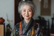 © ChaoticMind - Elderly woman wearing traditional kimono smiles warmly in a serene indoor setting