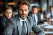 © vstudio - Confident businessman leading meeting dressed in sharp gray suit embodying professionalism and focused leadership