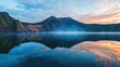 © Mioabang - Serene Sunrise Reflection over Volcanic Lake