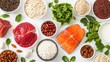 © 69 - Fresh ingredients arranged neatly on a white surface featuring fish, meats, grains, nuts, seeds, and greens beneficial for a balanced diet