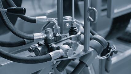 Poster - Part of a hydraulic industrial machine, control levers of a hydraulic machine, industrial  High pressure hydraulic hose system connected to steel pipes, close-up. Marine hydraulics. conceptconcept