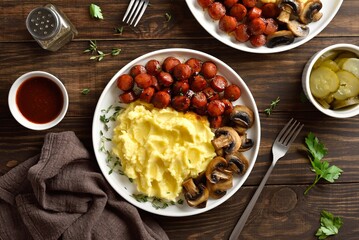 Wall Mural - Mashed potatoes with roasted sweet and spicy sausage bites and mushrooms