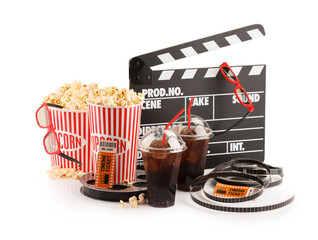 Wall Mural - Tasty popcorn, glasses, film reels, soda drinks, clapper and movie tickets isolated on white