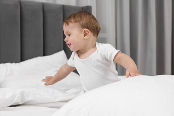 Wall Mural - Funny little baby playing on bed at home