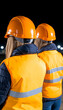 © bcendet - Construction workers inspecting site at night wearing safety vests and helmets