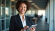 © Ada - Latin Hispanic mature adult professional business woman looking at camera and smiling. European businesswoman CEO holding digital tablet using fintech tab application standing at workplace in office