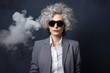 © pueb - Mysterious girl in dark glasses and chic outfit holding a cigarette against a gray backdrop
