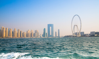 Poster - Dubai Marina beach skyscrapers, view at sunset from the boat. View include the Address Hotel and Dubai Eye 