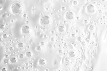 Wall Mural - White cosmetic gel texture background. Liquid, transparent cream swatch with bubbles, close-up.