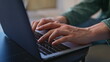 © stockbusters - Businessman fingers typing keyboard laptop office closeup. Smiling guy working