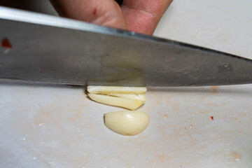 Wall Mural - cutting garlic with a knife