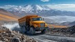 © Forger - Yellow dump truck navigating rocky terrain with mountains and blue sky in the background