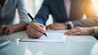 © Ernesto - A tax professional signing a document, emphasizing the final steps and professionalism of tax preparation.