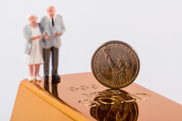 Wall Mural - Gold bar, 1 US dollar coin and symbolic figurines of pensioners