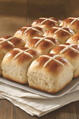 Canvas Print - Easter buns on a plate, cloth, and wooden table. Holiday dessert for spring celebrations