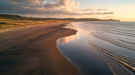 Wall Mural - Sunset Coastline Waves washing onto sandy beach; hills in background. Use scenic vacation