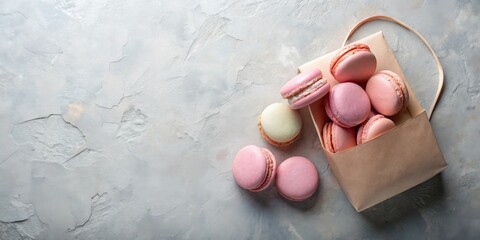 Wall Mural - Delightful Pink and Cream Macarons in a Paper Bag on a Textured Surface