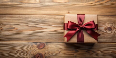 Poster - A thoughtfully wrapped gift with a rich burgundy ribbon, resting on a rustic wooden surface, ready for a special occasion