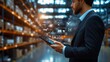 © Jdgkxbnc - Businessman Manager Using Digital Tablet for Logistics Control in Modern Warehouse Setting