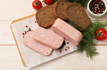 Wall Mural - Pieces of tasty canned meat, tomatoes, peppercorns, dill and bread on light wooden table, flat lay