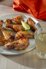 A view of a plate of tequila lime chicken wings.