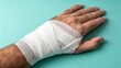 © Arugula Pica - Injured Hand of Man with Injury Wrapped in Gauze Bandage, First Aid, Emergency Room, Wound, Cut or Scratches, Close-up on Clean Neutral Background