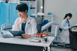 © ARMMY PICCA - Positive doctor working on laptop in medical office, portrait.