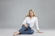 © New Africa - Woman in stylish jeans on grey background. Space for text