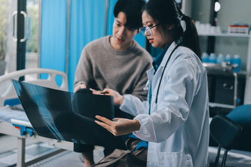 Wall Mural - Female physician reads medical history while visiting her patient