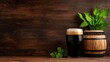 © VANATSANUN - A refreshing dark beer served in a glass beside a wooden barrel and green plant on a rustic wooden surface.