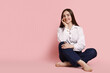 © New Africa - Smiling woman in stylish jeans on pink background. Space for text