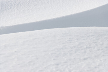 Wall Mural - shadow and light on sunlit fresh white winter snow surface