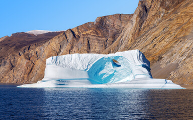 Wall Mural - large sculptural iceberg in northeast greenland national park. wind and water have weathered the ice