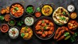 © Pat J. - Indian banquet with chicken tikka masala curry, tandoori chicken, and various appetizers on dark concrete background