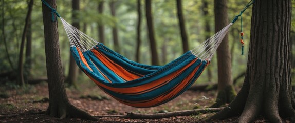 Fototapete - Colorful Striped Hammock Hanging Between Trees in Lush Forest with Space for Text Ideal for Outdoor and Camping Themed Designs