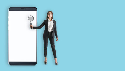 Wall Mural - Businesswoman holding magnifying glass near large smartphone with blank screen.