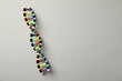 © New Africa - Colorful DNA structure model on light grey background, top view. Space for text