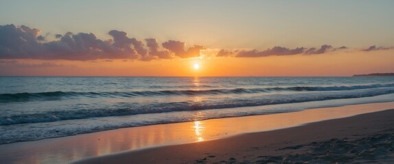 Wall Mural - sunset over the ocean with gentle waves and clouds in the sky reflecting warm colors copy space