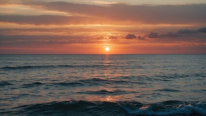 Wall Mural - Sunset over calm ocean water with gentle waves and clouds in the sky reflecting warm colors horizontal composition Copy Space