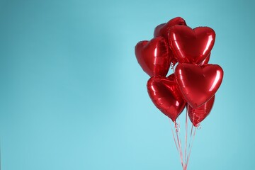 Wall Mural - Many red heart-shaped balloons on light blue background, space for text. Happy Valentine's Day