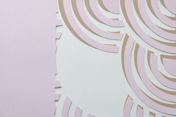 Wall Mural - overlapping pink on beige abstract machine-cut paper patterns with concentric arc shapes on blank paper