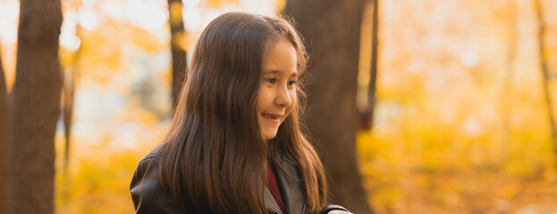 Wall Mural - Banner autumn portrait of cute little asian girl. Children, fall and season concept. Copy space