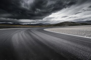 Wall Mural - A vacant asphalt road, wet with rain, set against a dramatic, stormy sky