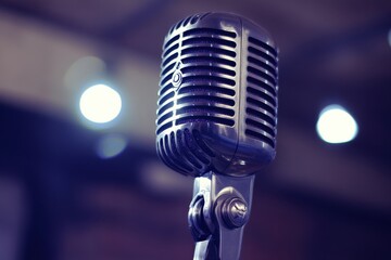 Poster - Classic retro microphone set against a blurred background of bright lights in a performance space. Generative AI