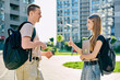 © Valerii Honcharuk - College students teenagers guy and girl with backpacks talking together, outdoor
